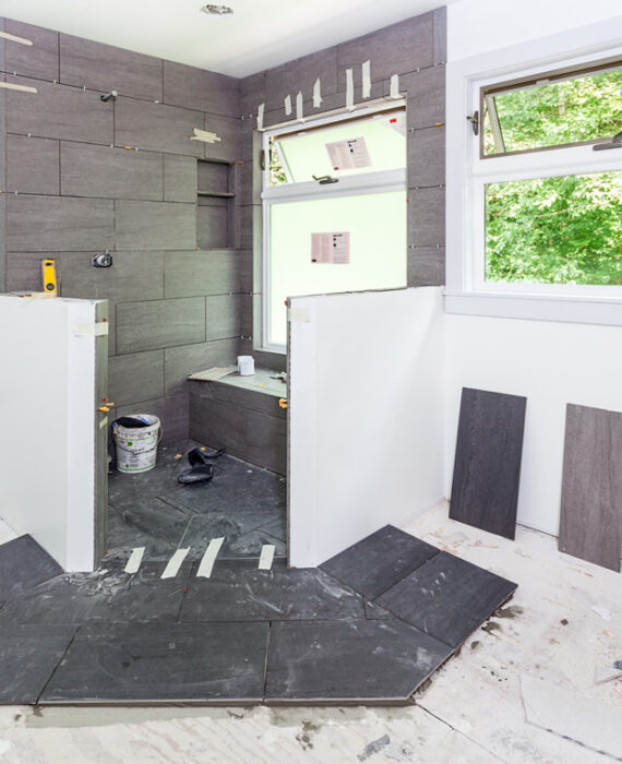 A white and grey bathroom being remodeled in El Paso.